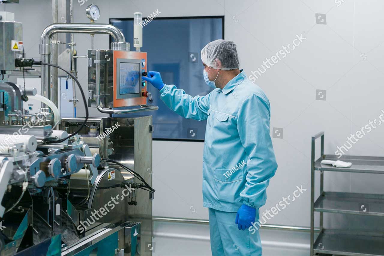 stock-photo-caucasian-scientist-in-blue-lab-suit-configures-control-panel-in-big-clean-room-568736914